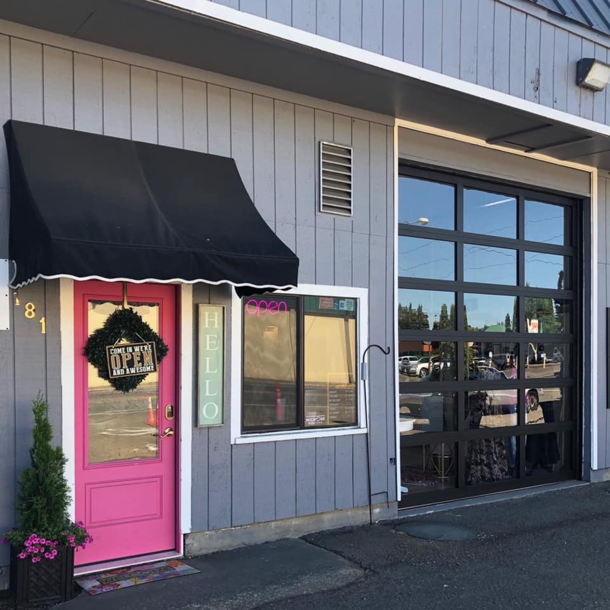 The pink door of Ellie May's Beauty Bar on S Ivy Street in Canby